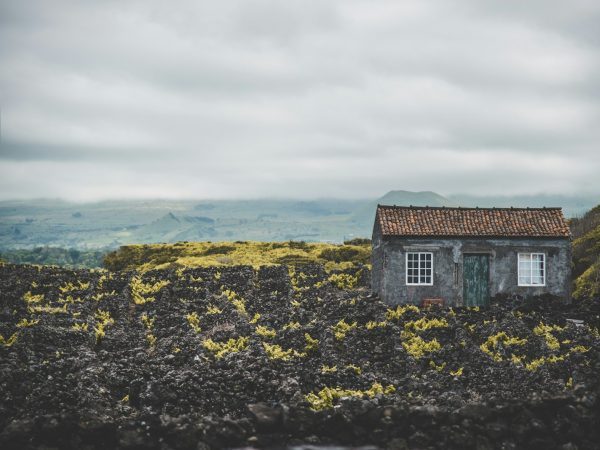 gray and brown house under cloudy sky
